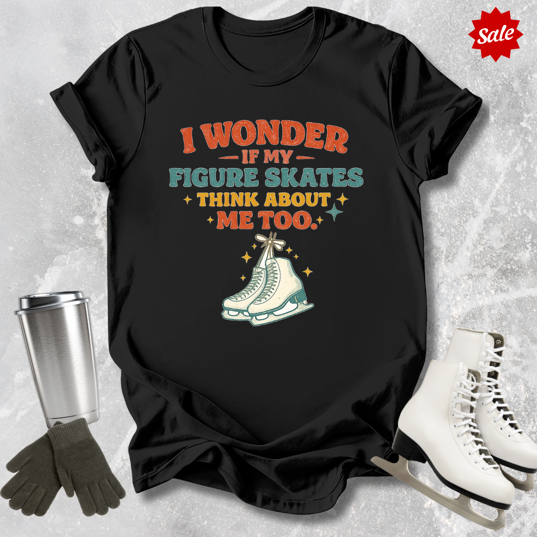 Black t-shirt with figure skating graphic and text on a textured gray background