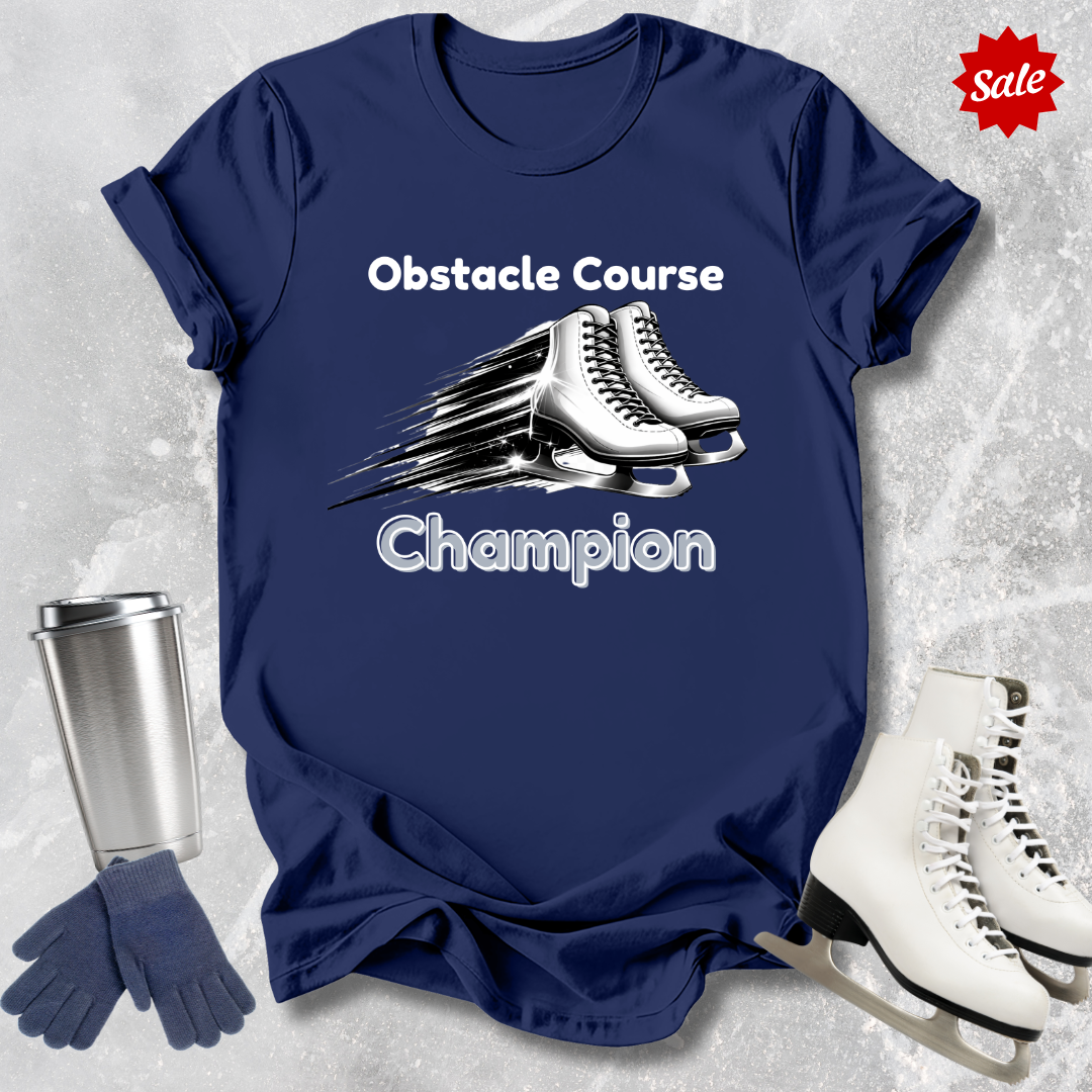 Navy blue t-shirt with 'Obstacle Course Champion' text and ice skates, surrounded by ice skates and a tumbler on a textured gray background.