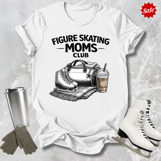 White t-shirt with 'Figure Skating Moms Club' design, surrounded by ice skates, gloves, and a cup on a textured gray background.