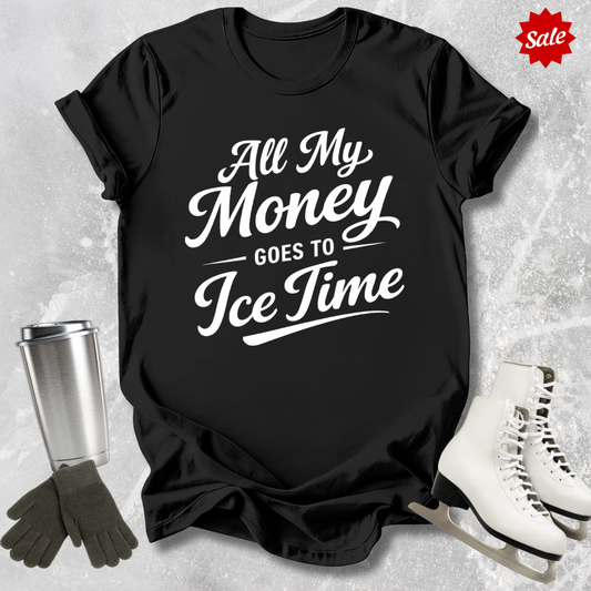 Black t-shirt with 'All My Money Goes to Ice Time' text, next to ice skates and a tumbler on a textured gray background.
