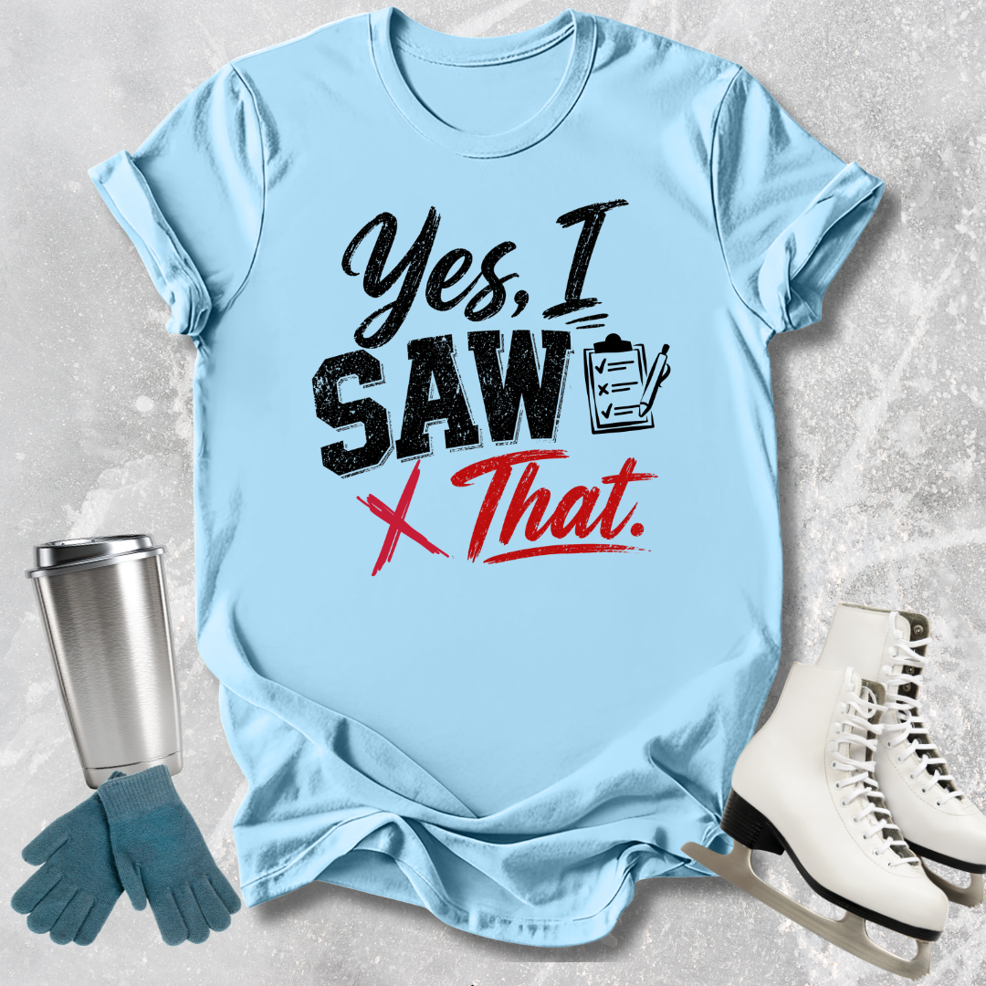 Light blue t-shirt with humorous text design, placed on a textured surface with accessories like gloves and skates.