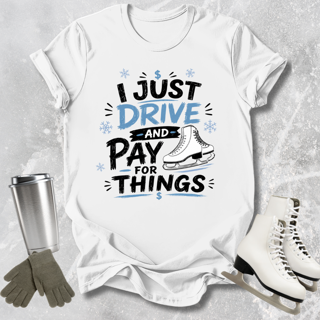 White t-shirt with humorous text design, surrounded by ice skates, gloves, and a tumbler on a textured surface.