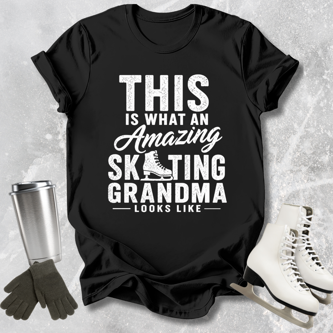 Black t-shirt with 'Amazing Skating Grandma' text on a textured surface with ice skates and gloves.