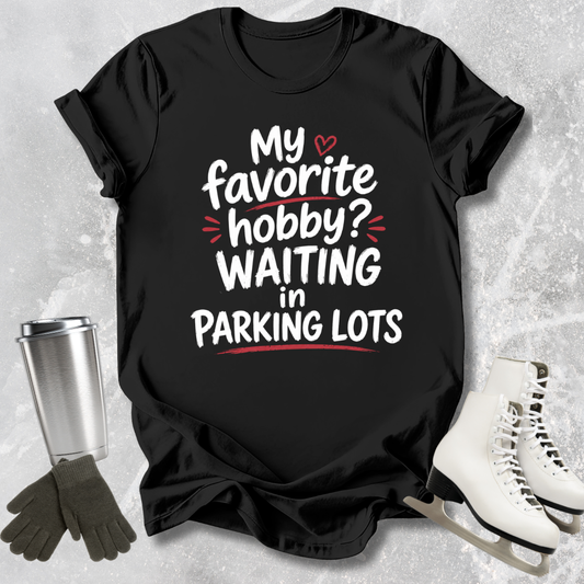 Black t-shirt with humorous text design on a textured surface with accessories.