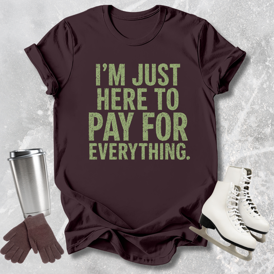 Brown t-shirt with green text, silver tumbler, brown gloves, and white skates on a textured gray background