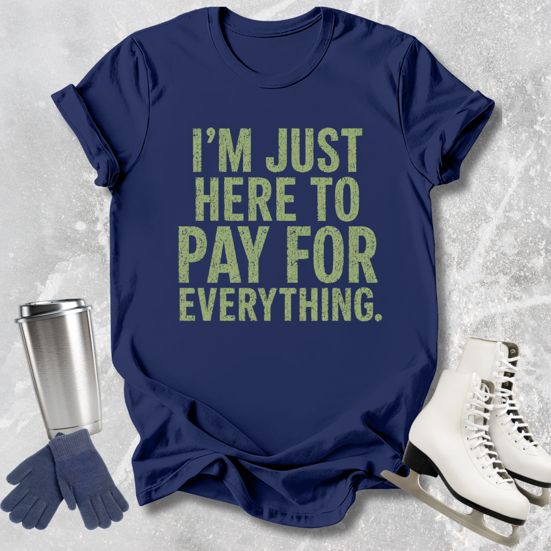 Navy blue t-shirt with humorous text, next to a silver tumbler, gloves, and white skates on a textured gray background.