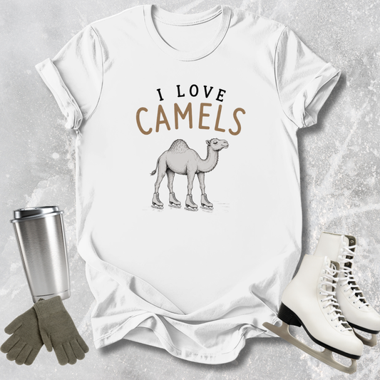 White t-shirt with 'I Love Camels' graphic, surrounded by a tumbler, gloves, and ice skates on a textured surface.