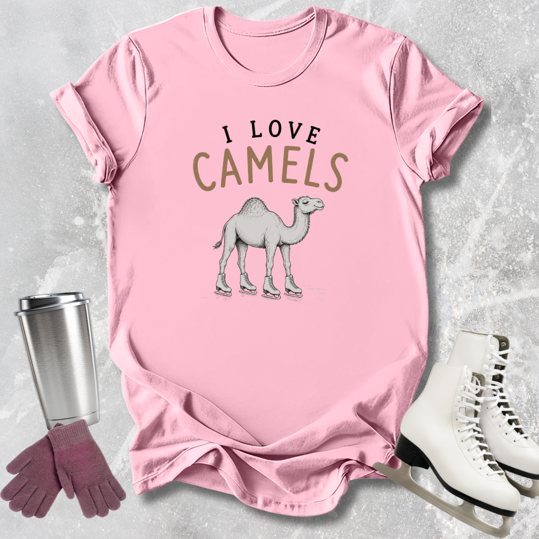 Pink t-shirt with 'I Love Camels' graphic, next to a silver tumbler, purple gloves, and white skates on a light gray background.