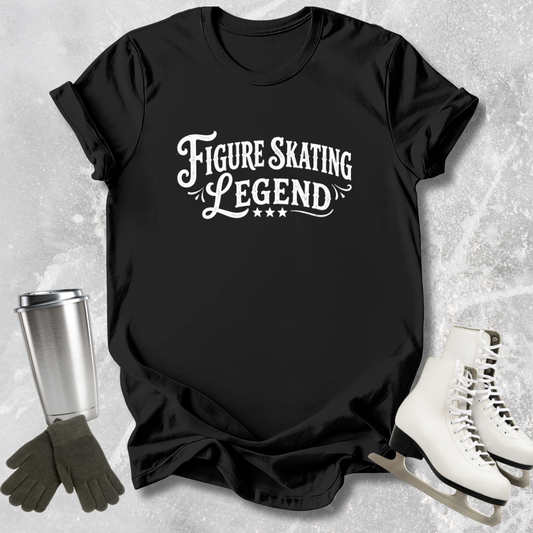 Black t-shirt with 'Figure Skating Legend' text, surrounded by ice skates and a tumbler on a textured gray background.