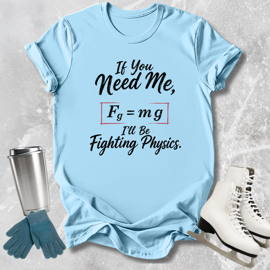 Light blue t-shirt with humorous physics text, placed on a textured surface with accessories like gloves and skates.