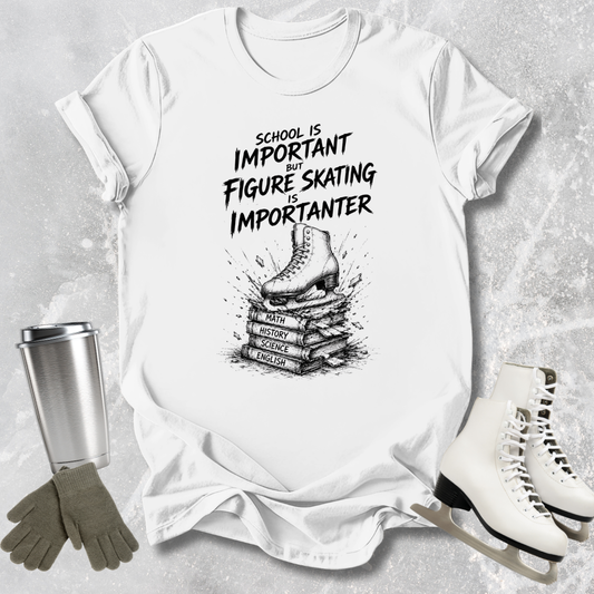 White t-shirt with figure skating design and text, surrounded by ice skates and a tumbler.
