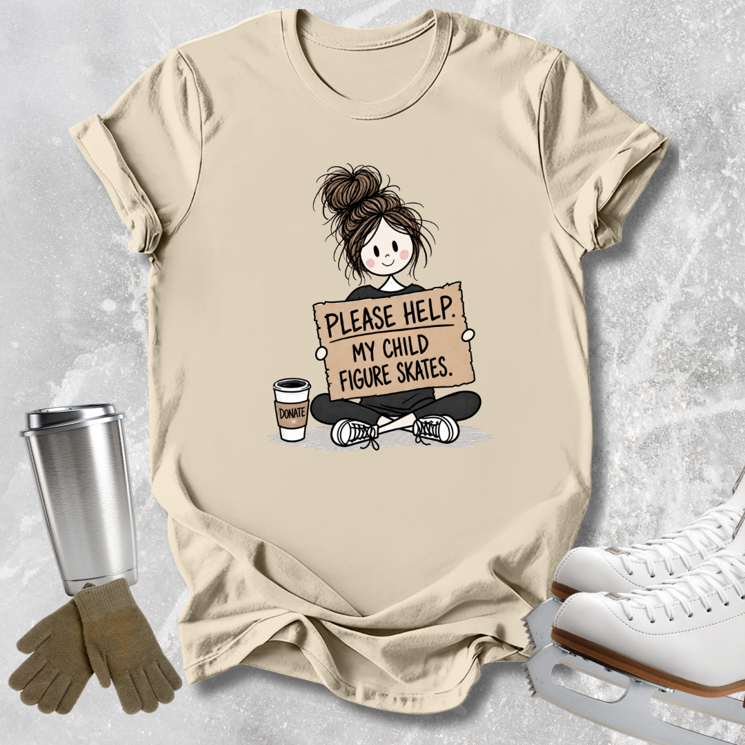 A beige graphic t-shirt laid flat on a textured gray background, styled with ice skates, gloves, and a metal tumbler. The t-shirt features a cartoon illustration of a girl with a messy bun holding a sign that reads 'PLEASE HELP MY CHILD FIGURE SKATES'.