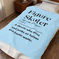 A light blue blanket with black printed text defining 'Figure skater' is draped over a bed in a bedroom setting.