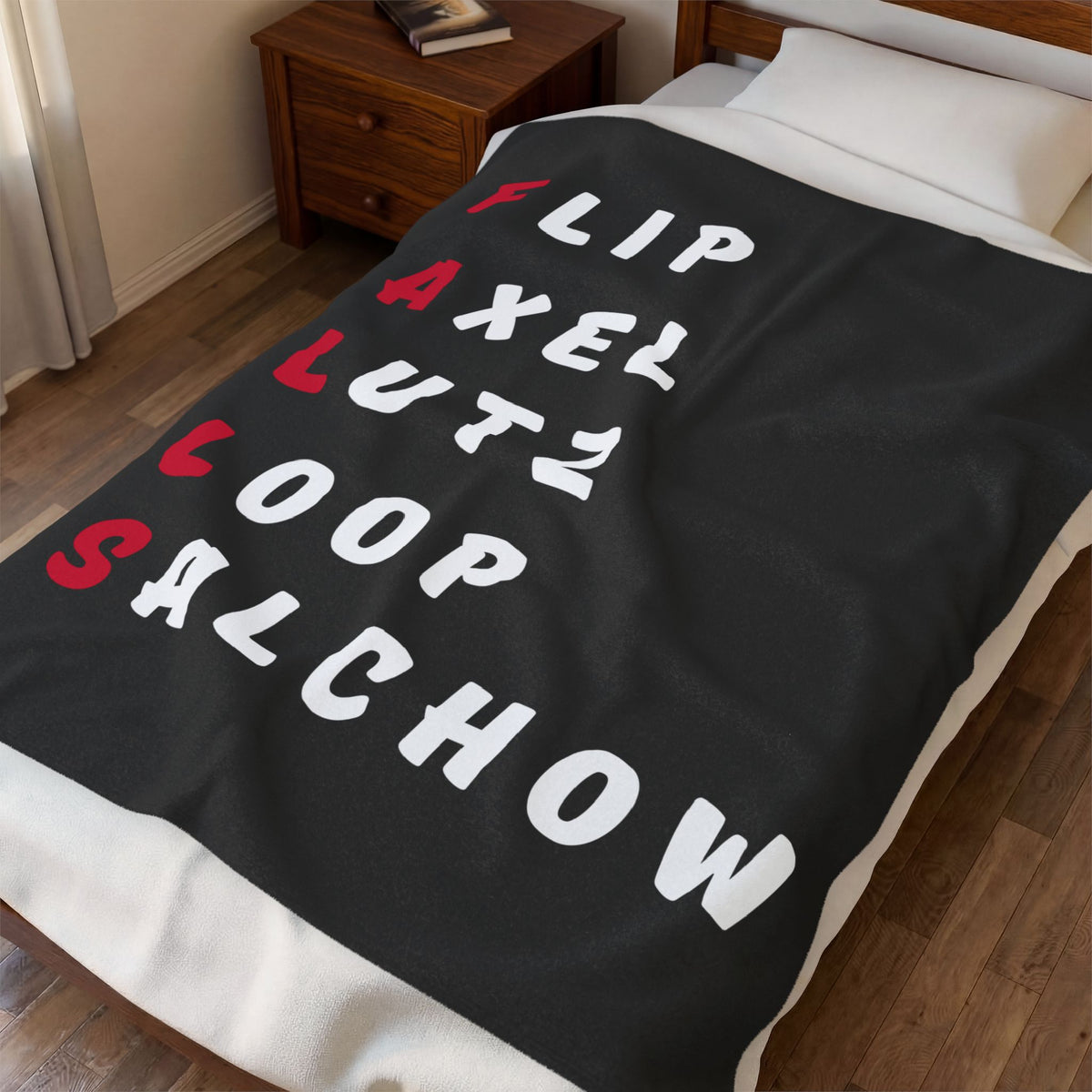 A black throw blanket with the word 'ROACH' spelled out in large white and red letters, draped over a bed in a bedroom setting.
