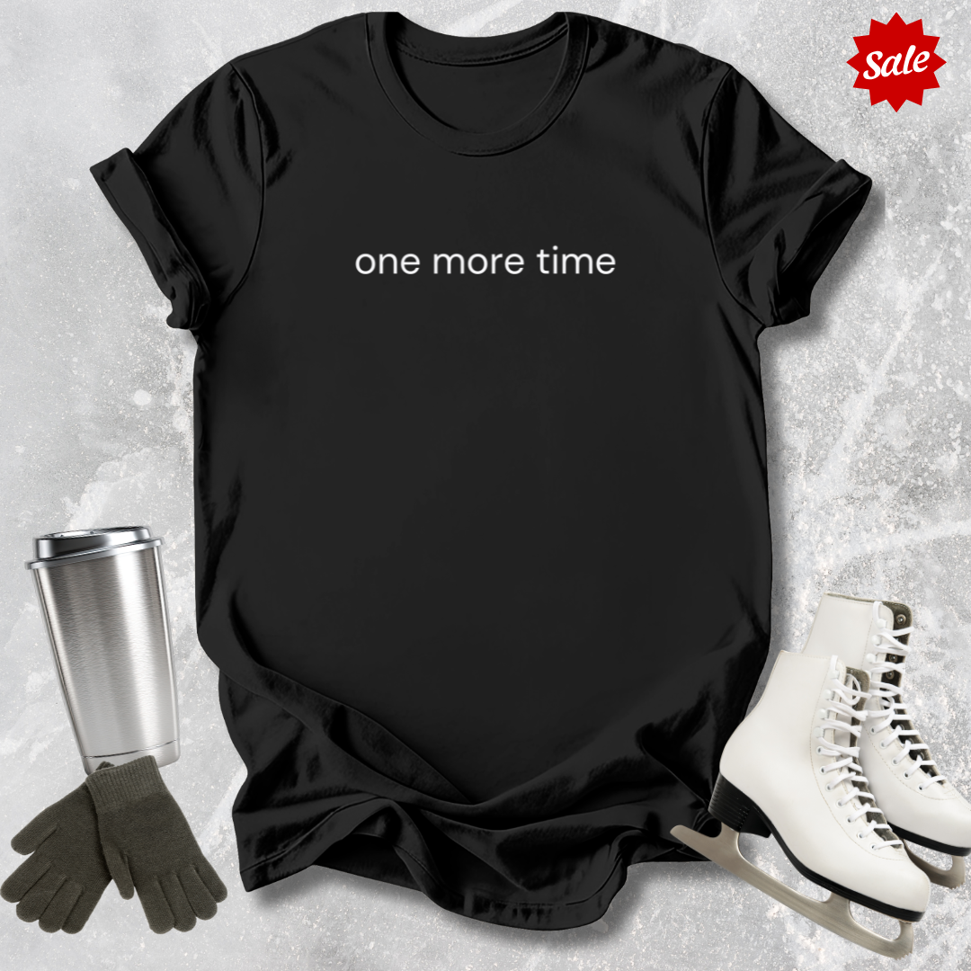 Black t-shirt with 'one more time.' text  for figure skating coaches,, silver tumbler, black gloves, and white skates on a textured surface.