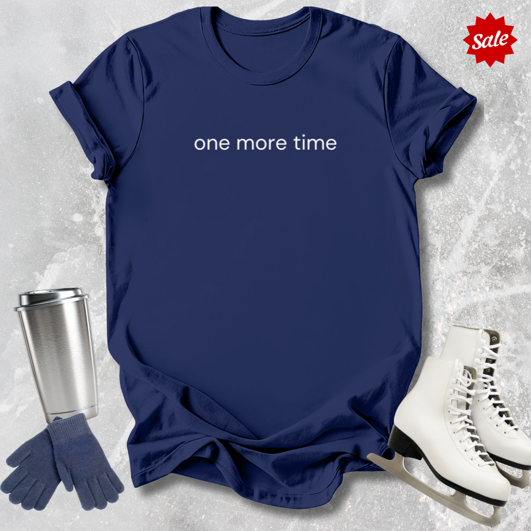 Navy blue t-shirt with 'one more time' text for figure skating coaches,, silver tumbler, gloves, and ice skates on a textured gray background.