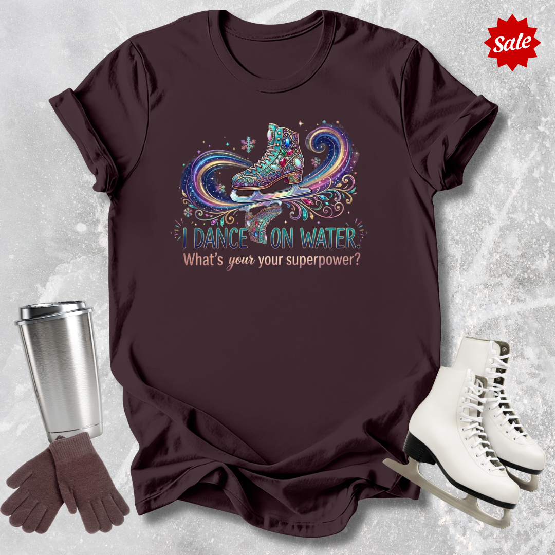 Brown t-shirt with  I dance on water ice skating design and accessories on a textured surface