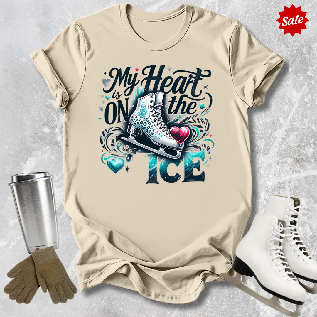 Beige t-shirt with ice skating design with my heart is on the ice text,  and accessories on a textured surface
