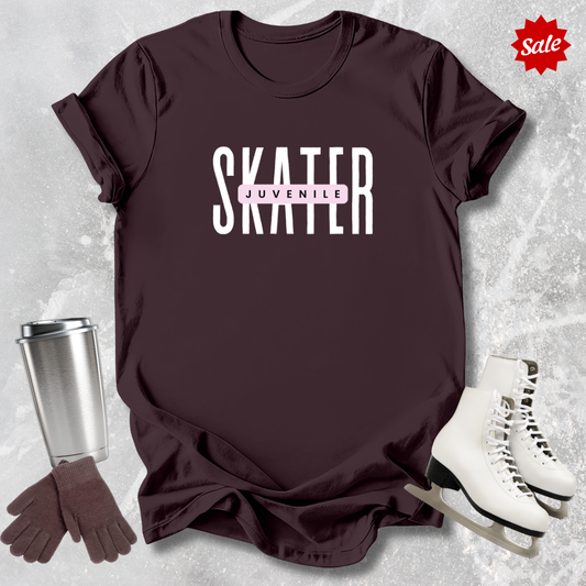 Maroon t-shirt with 'SKATER' text, silver tumbler, brown gloves, and white skates on a textured gray background.