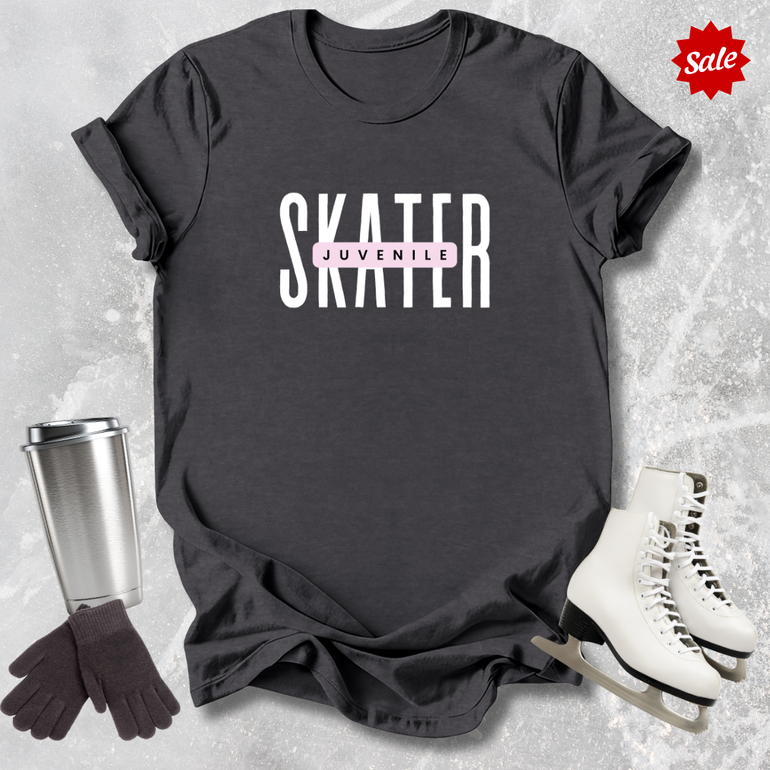 Black t-shirt with 'SKATER' and 'JUVENILE' text, surrounded by a silver tumbler, black gloves, and white skates on a textured gray background.