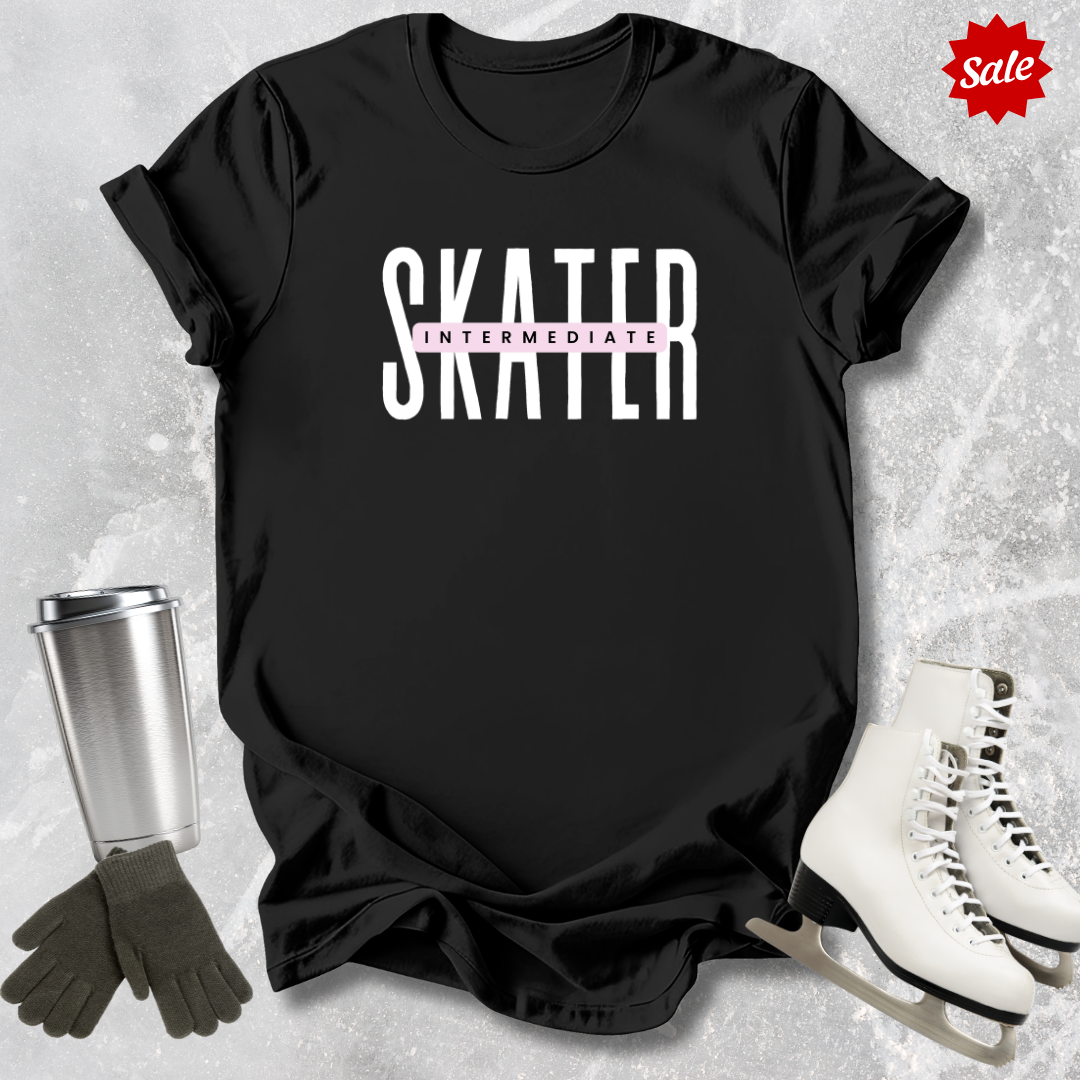 Black t-shirt with 'SKATER INTERMEDIATE' text, silver tumbler, black gloves, and white skates on a textured gray background.