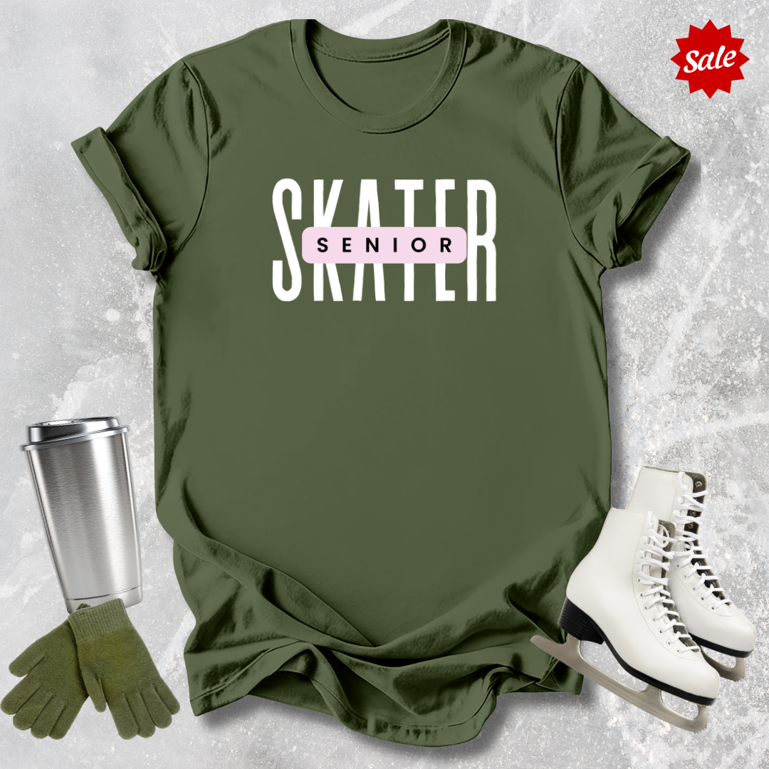 Green t-shirt with 'SKATER SENIOR' text, silver tumbler, green gloves, and white skates on a textured gray background.