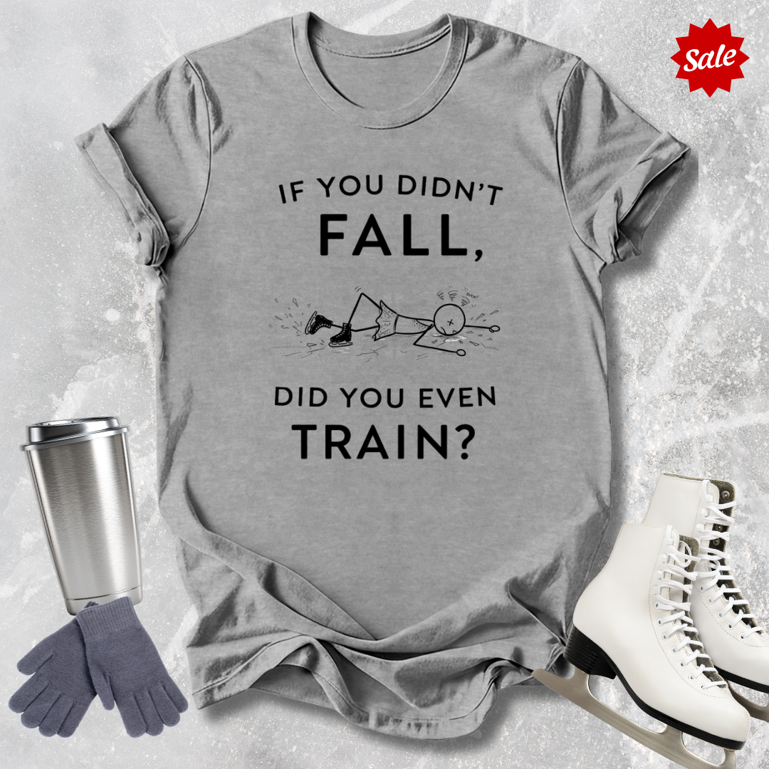 Gray t-shirt with humorous if you didn't fall did you even train text, next to a silver tumbler, gray gloves, and white skates on a light gray background.