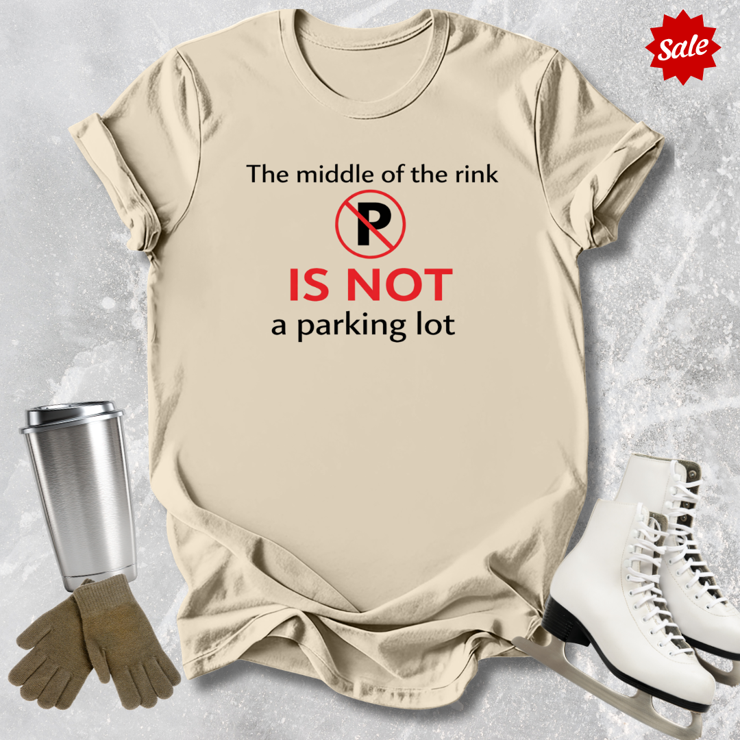 Beige t-shirt with humorous text design, placed on a textured surface with ice skates and a tumbler for scale.