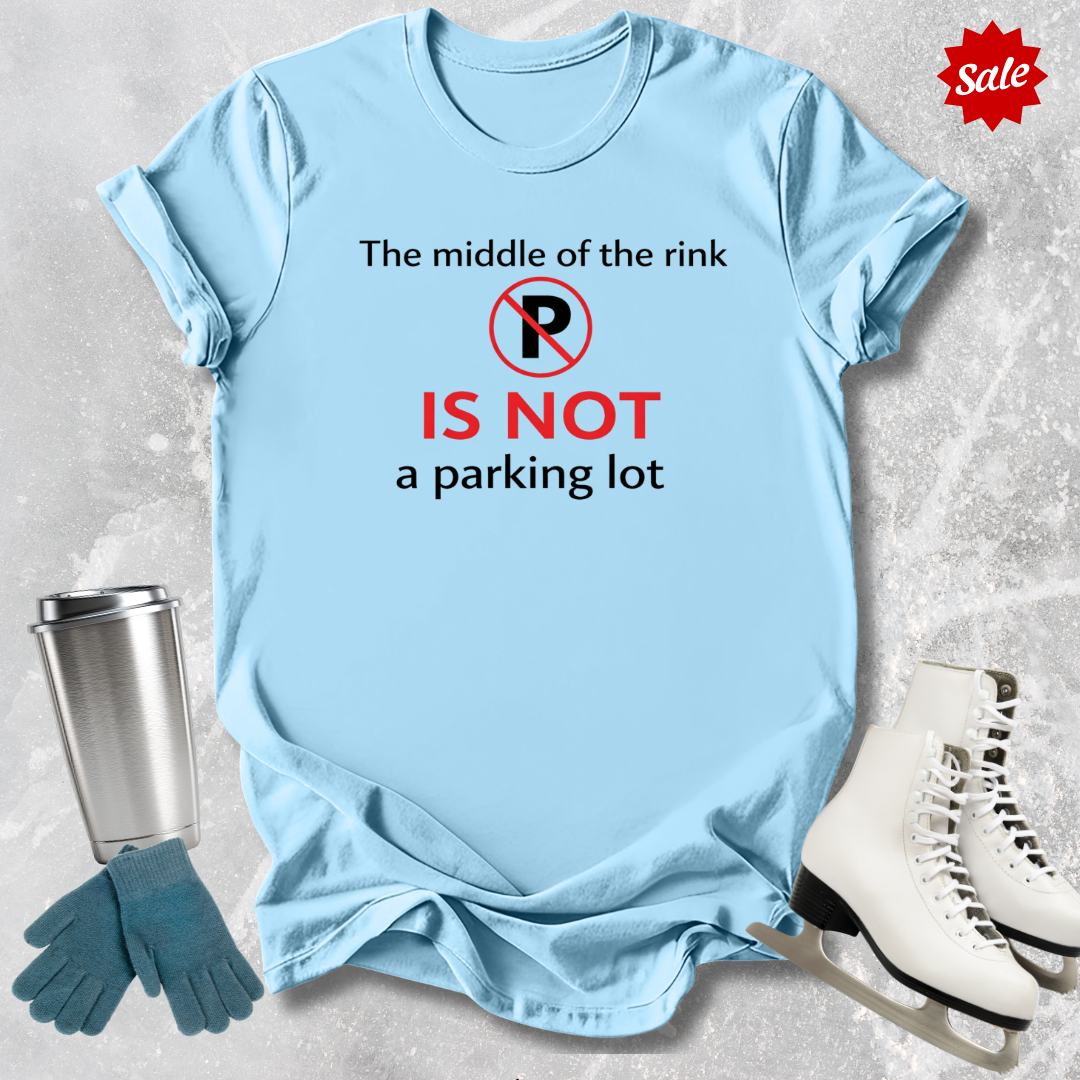 Light blue t-shirt with humorous text design, placed on a textured surface with ice skates and a tumbler for context.