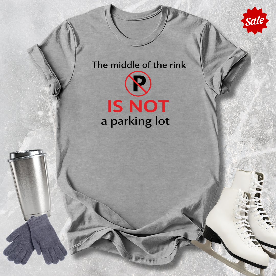 Gray t-shirt with humorous text design, placed on a textured surface with ice skates, gloves, and a tumbler for sale.