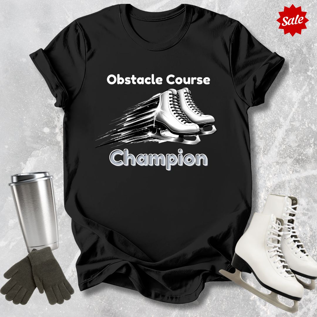 Black t-shirt with 'Obstacle Course Champion' text and ice skates, surrounded by ice skates and a tumbler on a textured gray background.