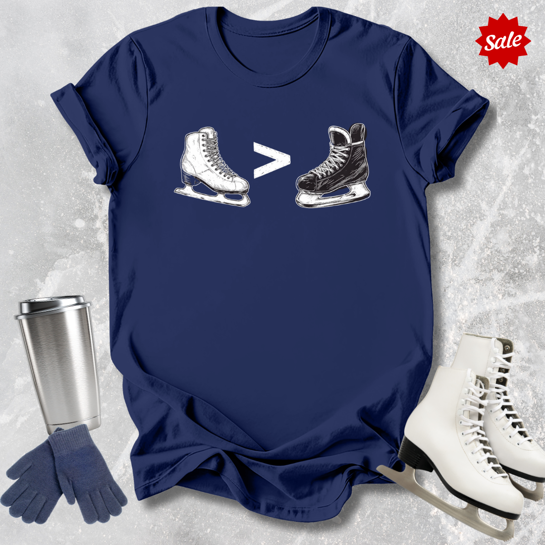 Navy t-shirt with  a funny figure skating is greater than hockey graphic, silver tumbler, blue gloves, and white ice skates on a textured gray background.
