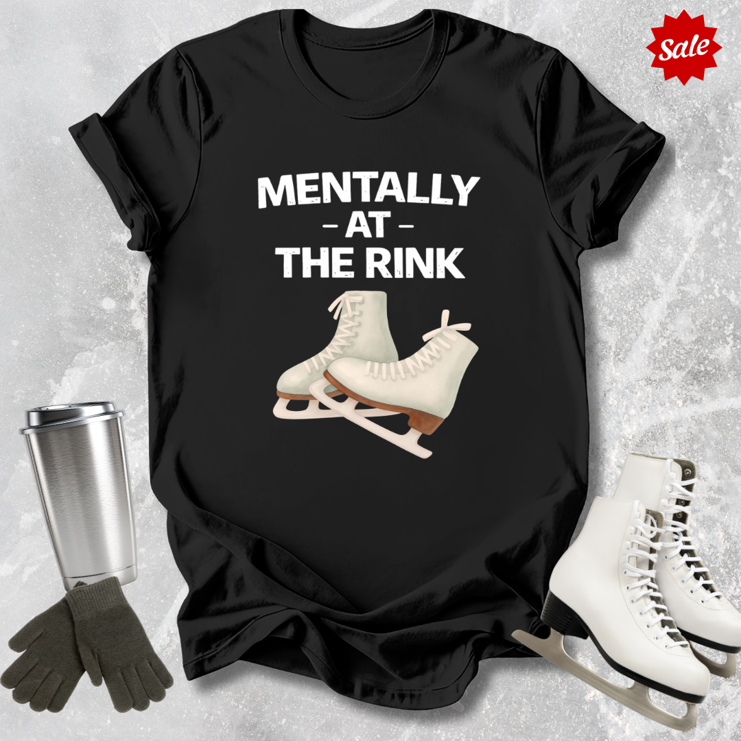 Black t-shirt with ice skates and text 'Mentally at the Rink' on a textured gray background.