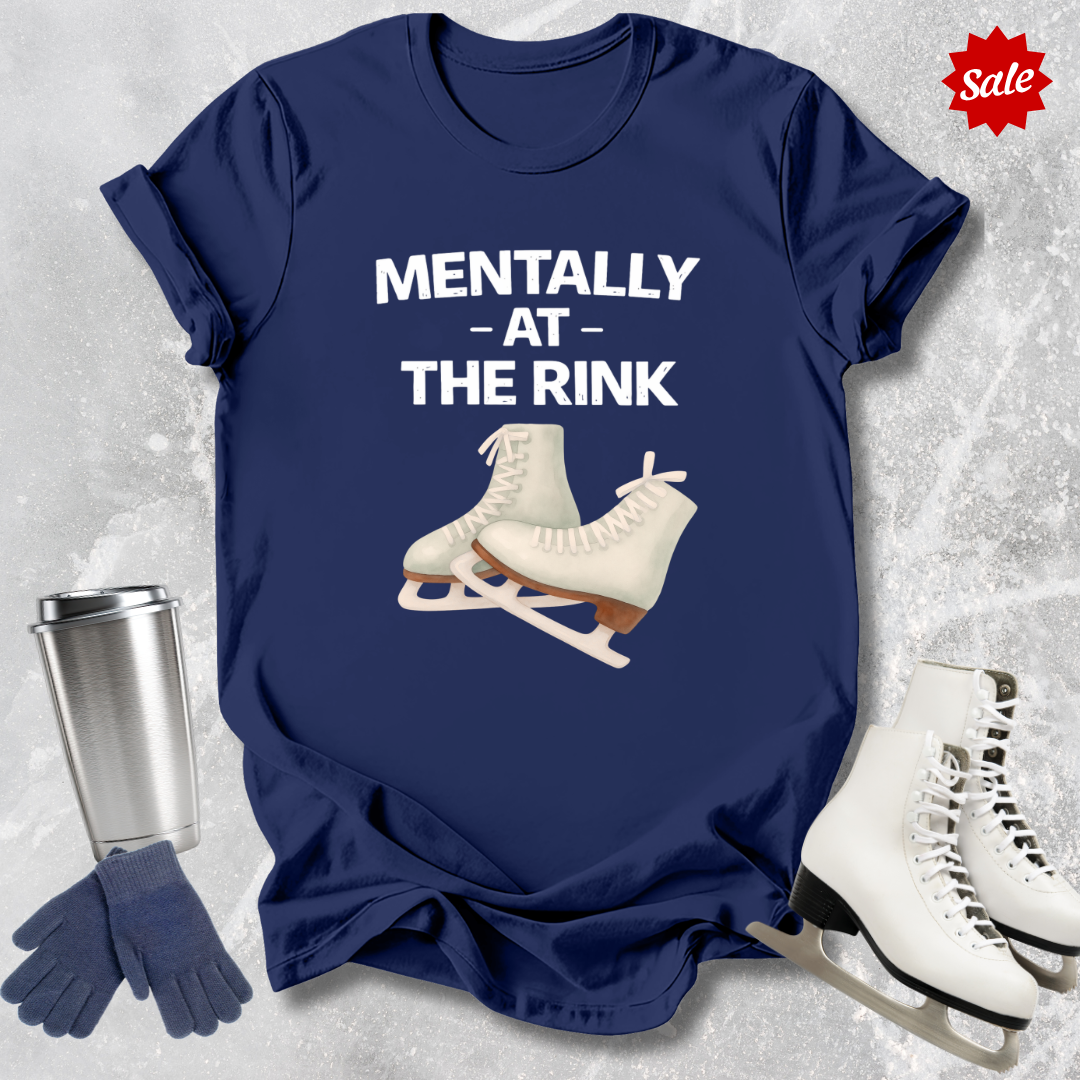 Navy blue t-shirt with ice skates graphic and text 'Mentally at the Rink' on a textured gray background.