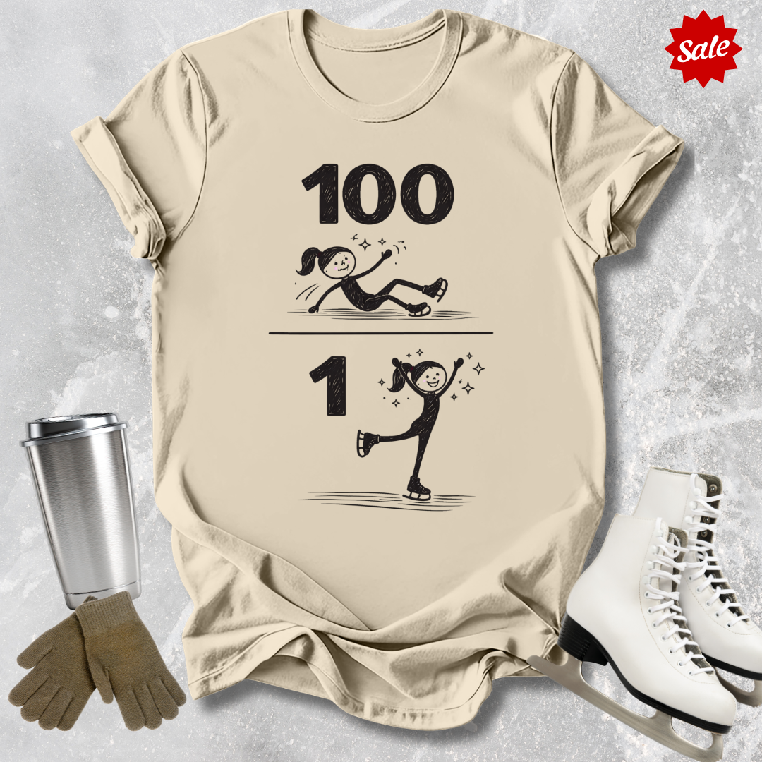 Beige t-shirt with roller skating design and text, placed on a textured surface with ice skates and a tumbler.