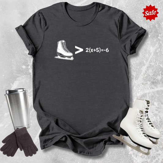 Black t-shirt with ice skate graphic and math equation, surrounded by ice skates and a tumbler on a textured surface.