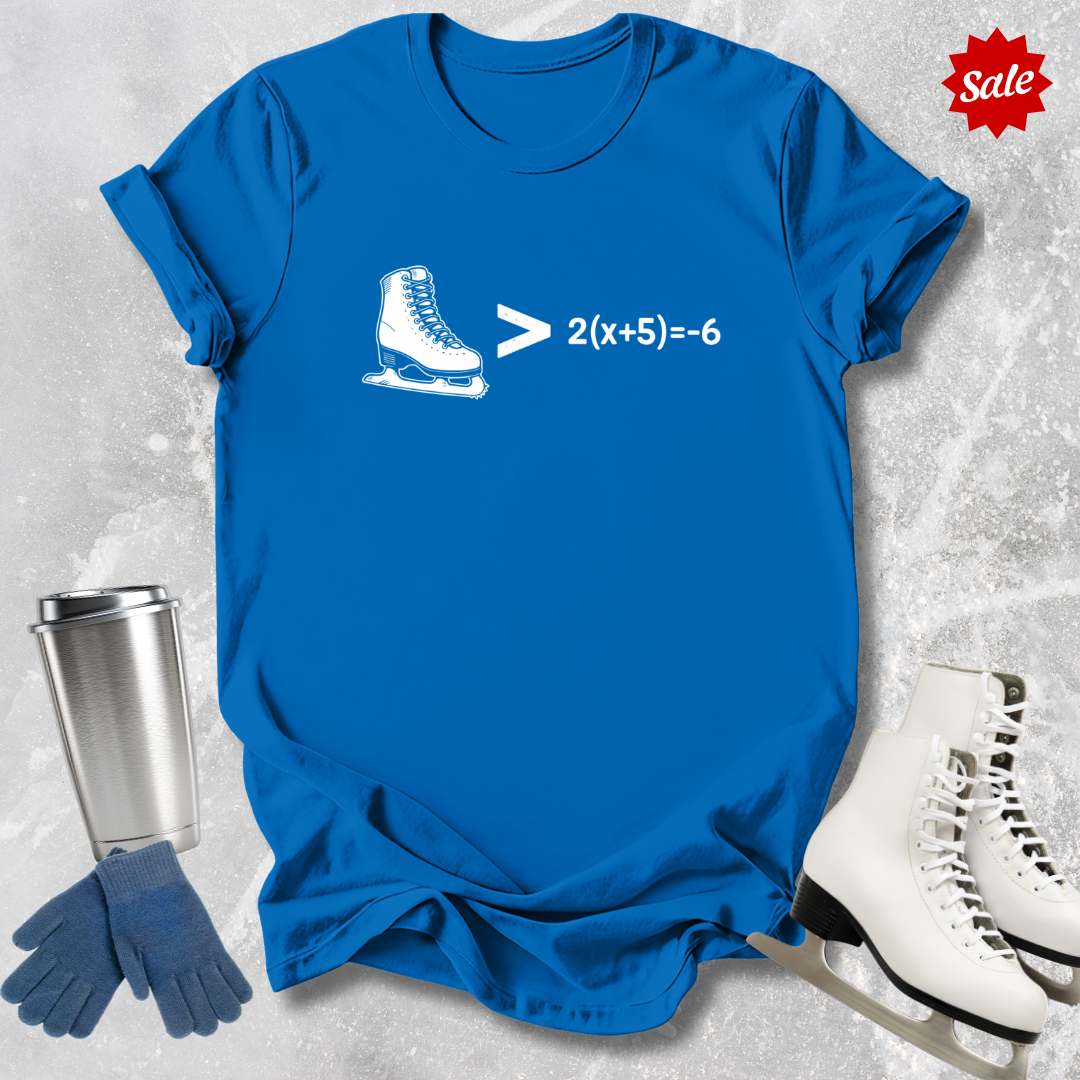 Blue t-shirt with ice skate graphic and math equation, surrounded by ice skates, gloves, and a tumbler on a textured surface.