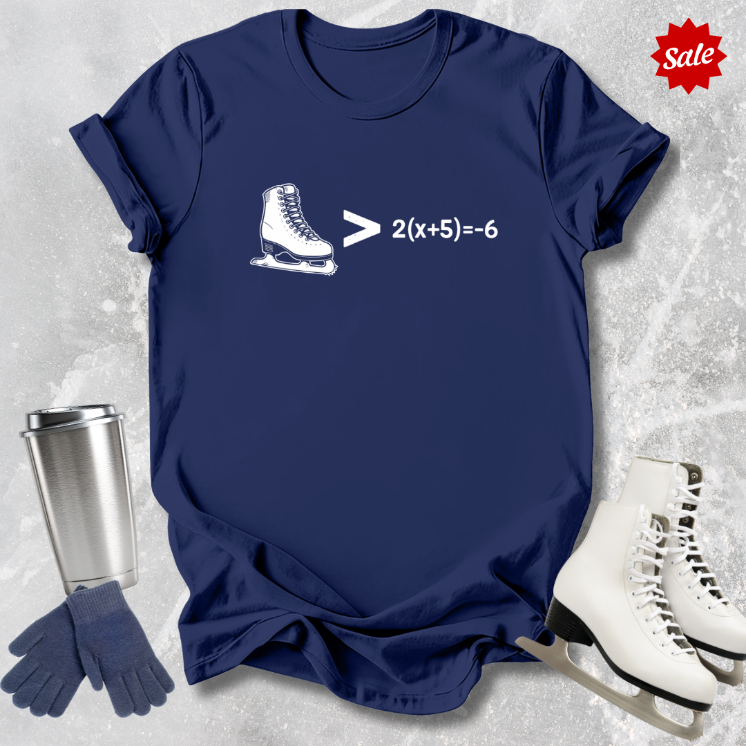 Navy blue t-shirt with ice skate graphic and math equation, surrounded by ice skates and a tumbler on a textured gray background.