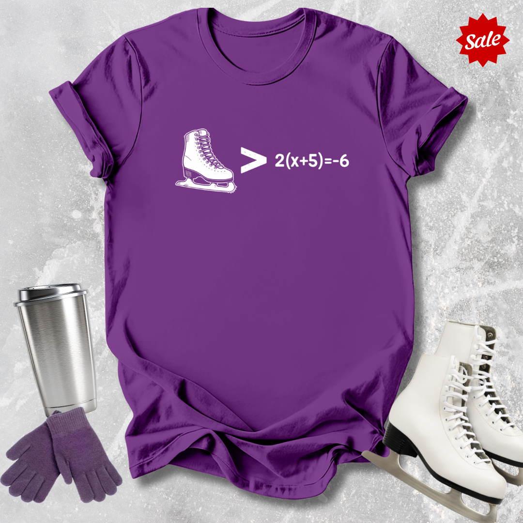 Purple t-shirt with ice skate graphic and mathematical equation, next to white skates and a silver tumbler on a light gray background.