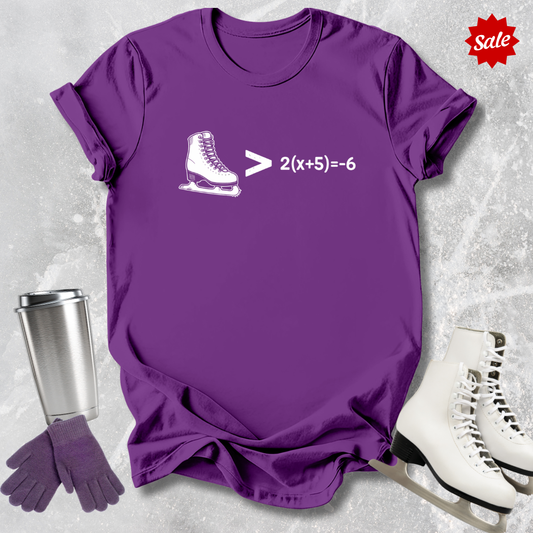 Purple t-shirt with ice skate graphic and mathematical equation, next to white skates and a silver tumbler on a light gray background.
