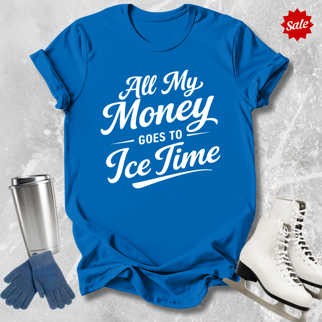 Blue t-shirt with 'All My Money Goes to Ice Time' text, next to a silver tumbler, blue gloves, and white skates on a light gray background.