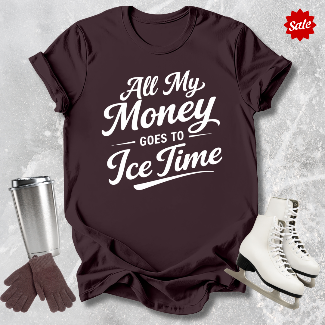 Brown t-shirt with 'All My Money Goes to Ice Time' text, next to a silver tumbler, brown gloves, and white skates on a light gray textured background.