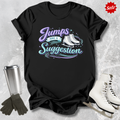 Black t-shirt with 'Jumps are a Suggestion' text, silver tumbler, black gloves, and white ice skates on a textured gray background.