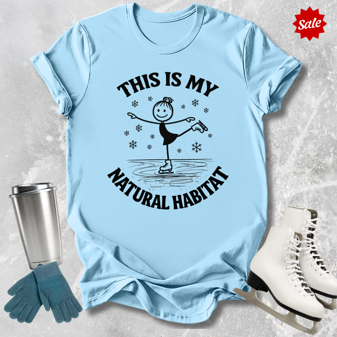 Light blue t-shirt with black graphic and this is my natural habitat skater text, placed on a textured surface with a sale tag.