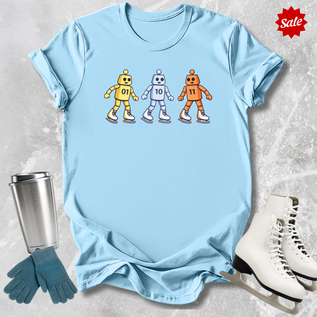 Light blue t-shirt with robot design, next to a silver tumbler, green gloves, and white skates on a textured surface.