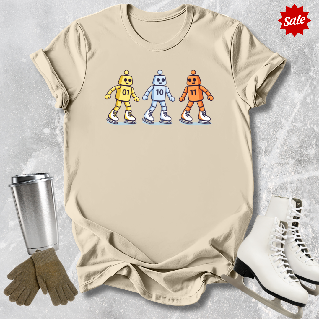Beige t-shirt with robot design, silver tumbler, brown gloves, and white skates on a textured surface.