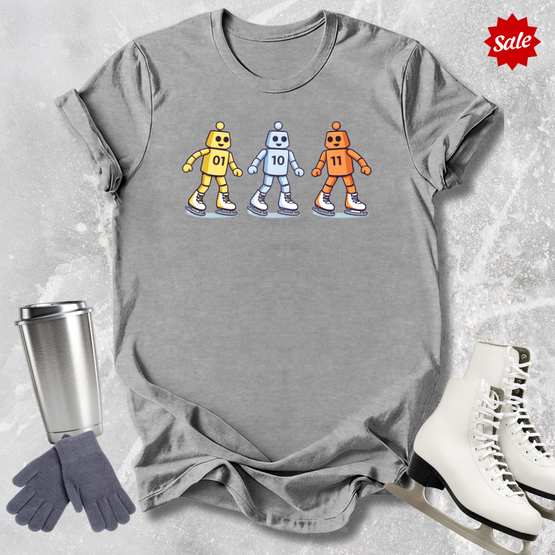 Gray t-shirt with robot design, silver tumbler, gray gloves, and white skates on a textured surface.