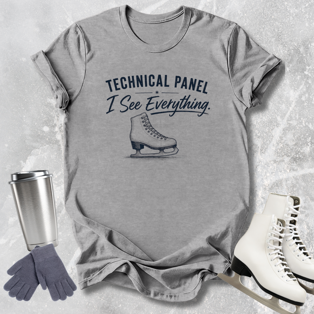 Gray t-shirt with 'Technical Panel I See Everything' text and ice skate graphic, surrounded by ice skates and a tumbler.