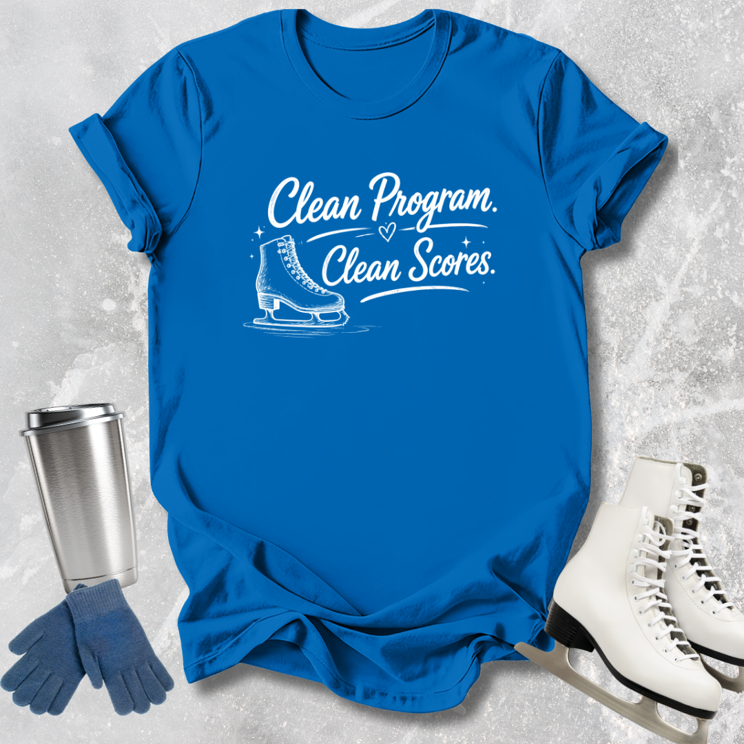 Blue t-shirt with ice skate graphic and text, next to ice skates and a tumbler on a textured surface.