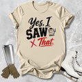 Beige t-shirt with humorous text design, placed on a textured surface with accessories like a tumbler, gloves, and skates.
